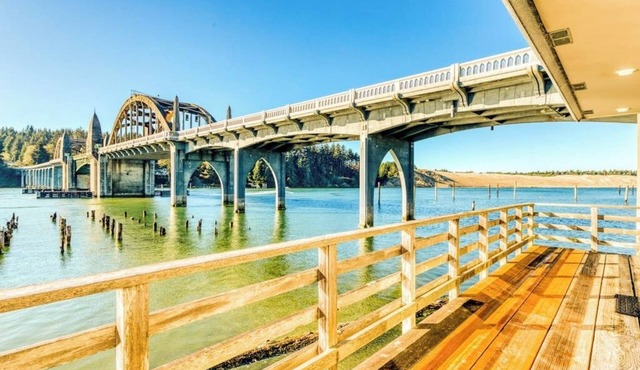 Incredible Riverfront Oasis with Wraparound Deck & Cozy Interior