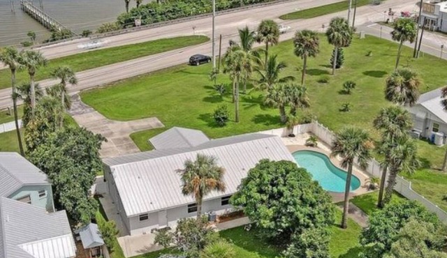 Indian River Waterfront Home with private dock, heated pool, fenced back yard