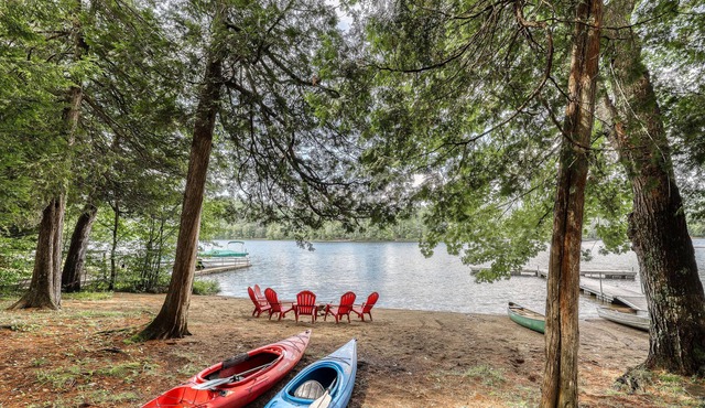 Inviting lakefront house with dock, sandy beach & screened porch