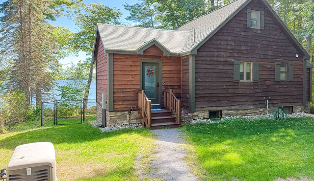 Inviting Lakeside Home with direct dock access, patio seating, and gas fireplace