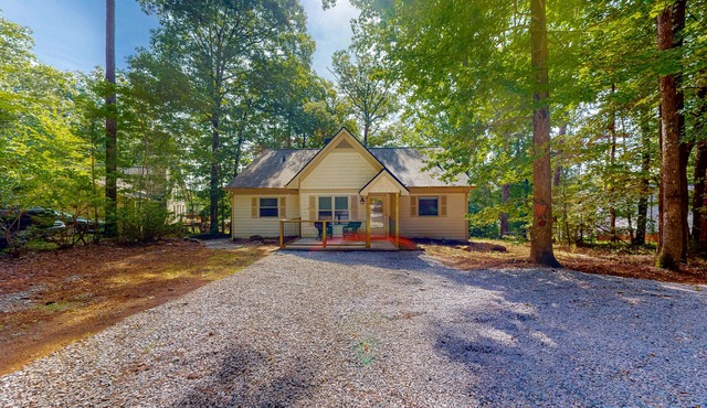 Inviting waterfront home with fireplace, dock, patio, central AC, & W/D