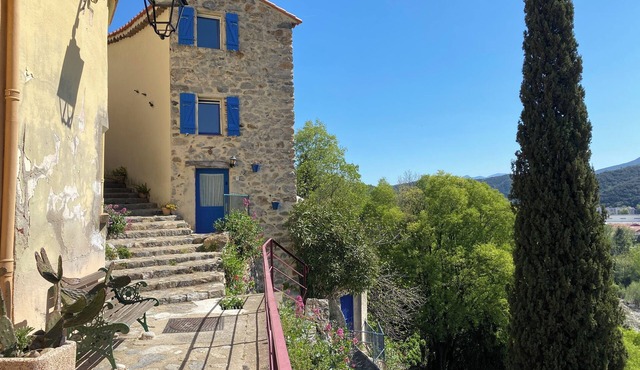 it's a blue house, clinging to the hillside in the charming village of Palalda