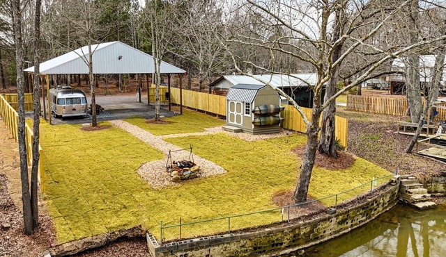 Johnny's Lake Escape lakeside covered Airstream: firepit, outdoor seats; kayaks