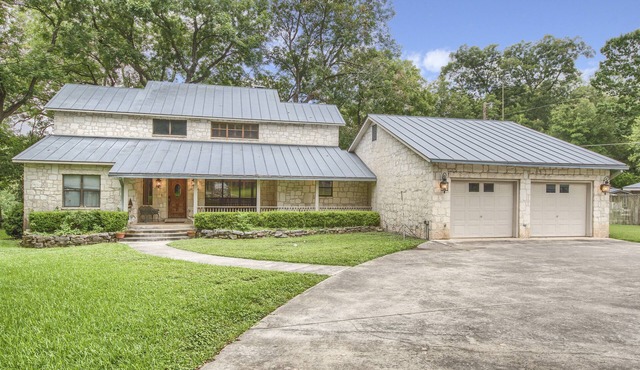 Jump right in the river at this gated, 2 acre Guadalupe Riverfront home!