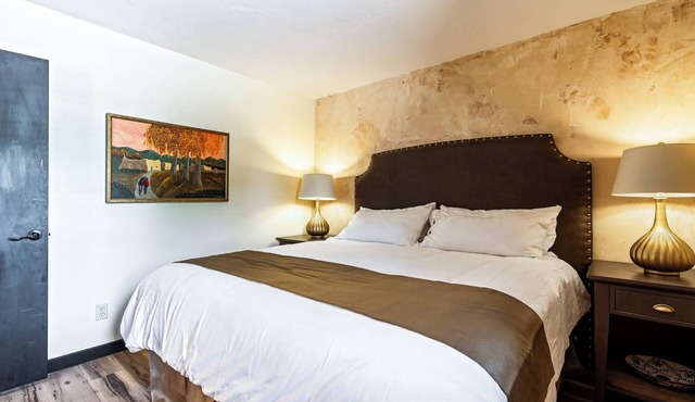 King Suite, kitchenette, private fenced patio with shared laundry and sauna on site.