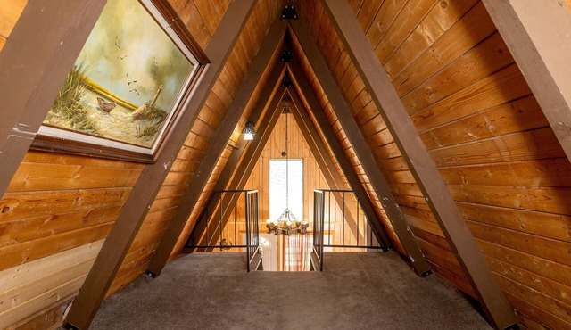 Knotty Pine Chalet has a huge front deck and fully fenced yard .