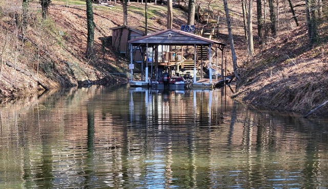 Lake Front. Large shaded deck with Covered Dock access. Fire pit.
