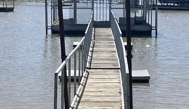 Lake front retreat, covered boat dock, large deck, fenced play area, RV parking