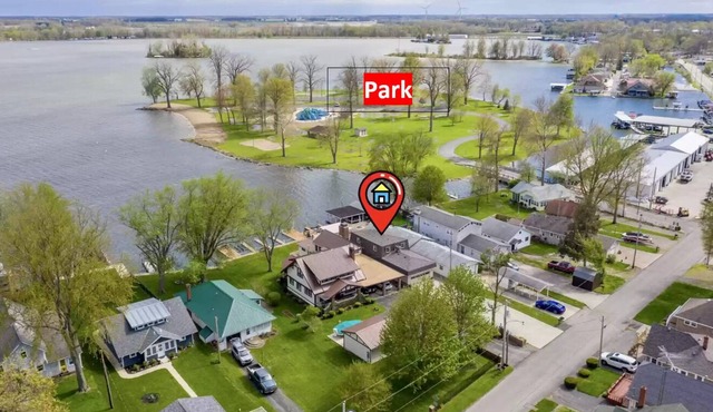 Lakefront, covered patio, open water views with boat dock.