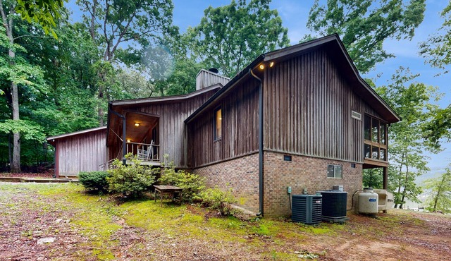 Lakefront home in the woods with dock, den, & private hot tub - dog-friendly