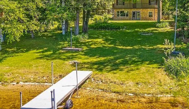 Lakefront home with large yard, dock, gas grill, WIFI near golf & ATV trails!