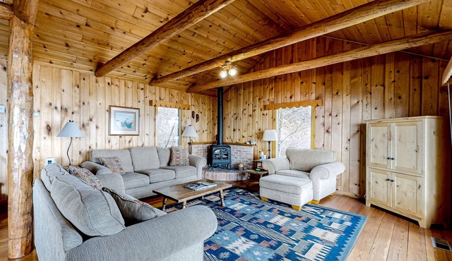 Lakefront home with amazing mountain views, wraparound deck, fireplace, & grill