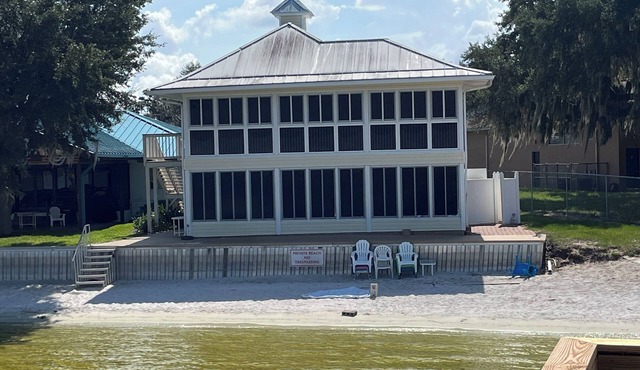 Lakefront home with white sand beach and private boat dock on Crooked Lake.