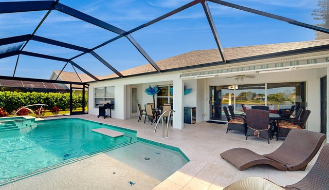 Lakefront home with private heated outdoor pool, enclosed lanai, & central AC