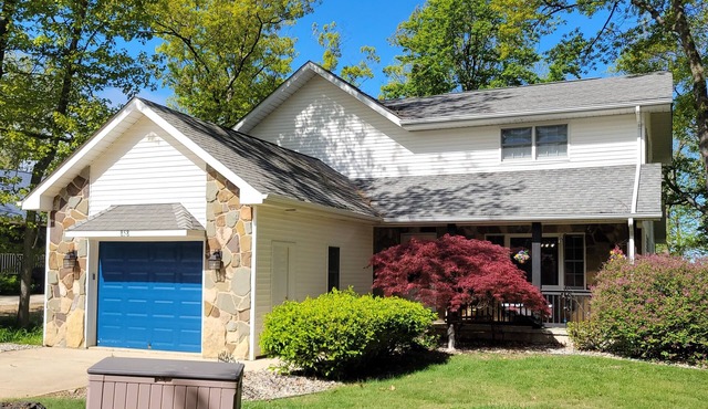 Lakefront house with decks and gazebo, 5 bedrooms on private beach.
