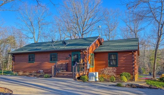 Lakefront living with direct beach access, two docks, boat house, firepit, & bar