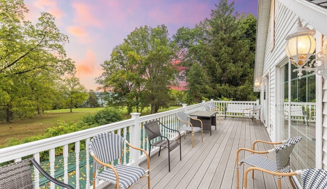 Lakefront luxury at its finest—two homes, a private beach, and spectacular Cayuga Lake views.