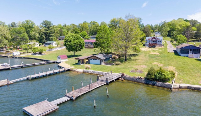Lakefront Radford retreat with private dock, deck dining, Roku TV, and cozy queen bedrooms.