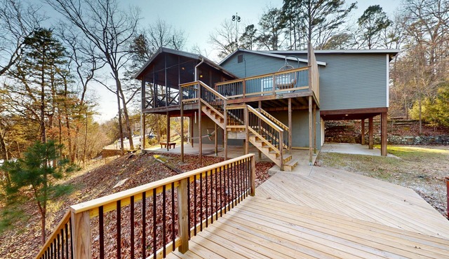 Lakefront retreat with screened sunroom, wood stove, multiple decks, & AC
