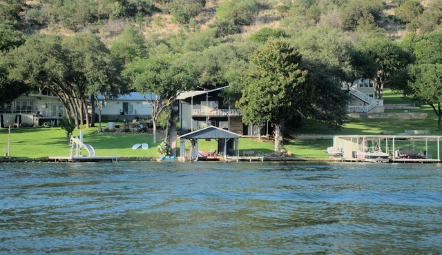 Lakefront retreat on quiet cove with large deck and sweeping views.