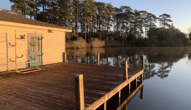 Lakeside pavilion on private lake with a boathouse, outdoor fireplace, kayaks.