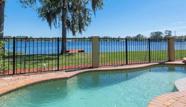 Lakeside Retreat~ Large home with pool, dock, game room and balcony on lakefront