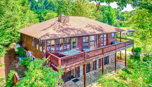 Lakeside retreat with water views, pool, wraparound deck, patio & game room
