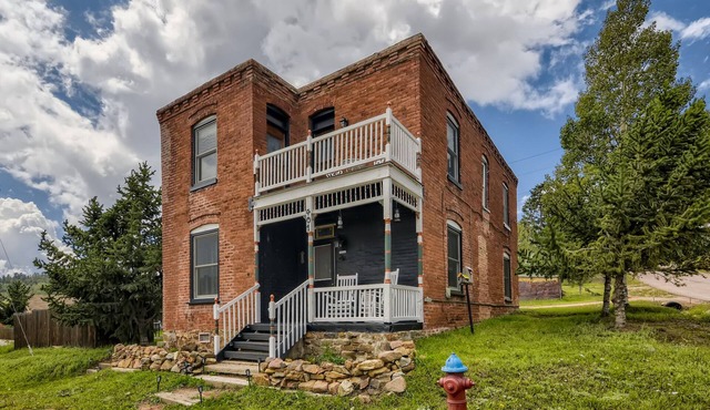 Landmark home built in 1895 with porches, office & western-themed decor