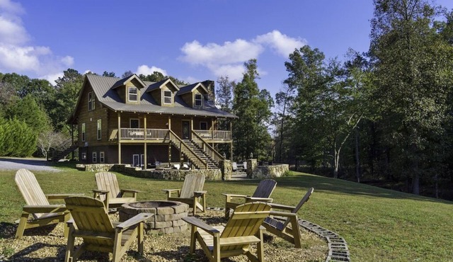 Large authentic 3-story log cabin adjacent to lake. Up to 14 guests.