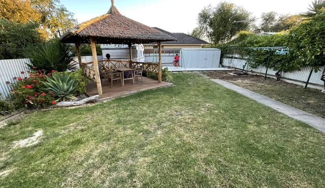 Large backyard with outdoor seating and BBQ!