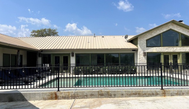 Large home with a pool sitting on the tee of the first tee box