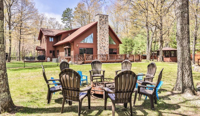 Large lakeside home with hot tub, gazebo, dock, firepit, and fenced in yard!