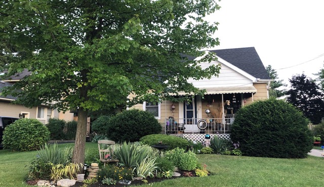 Large private fenced yard with guest patio, fire pit and surrounding gardens.