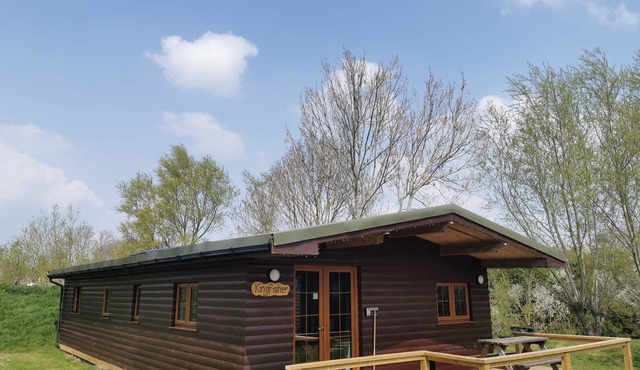 Large three bedroom lodge with private hot tub on the banks of the river Brue.