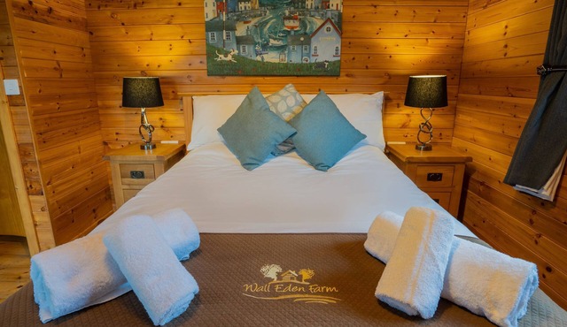 Large three bedroom log cabin with private hot tub and decking over looking the beautiful river Brue