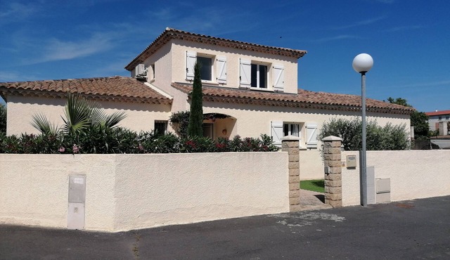 Large villa with swimming pool in a residential area close to the beach.