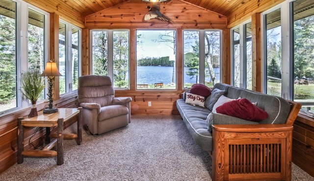 Level lakefront property with spacious cabin, private dock, and fire pit!