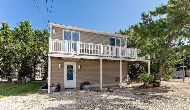 Light filled carriage house with gorgeous wrap around deck, ready for a perfect vacation getaway.