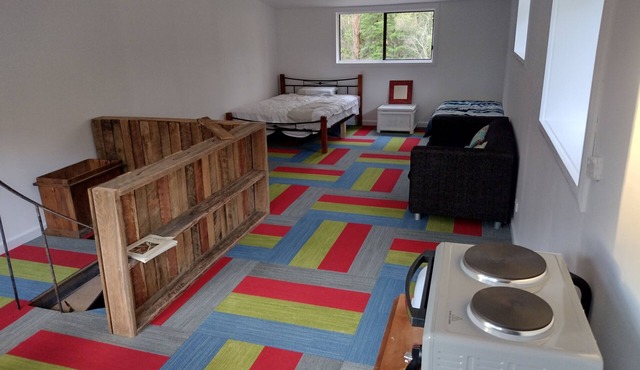 Loft on quiet 5 acre bush block. Less than 5 minutes to beaches.