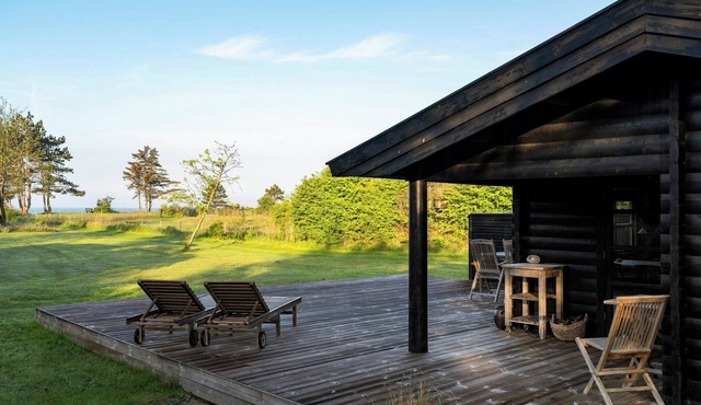 Log cabin in first row by Sejerø Bay