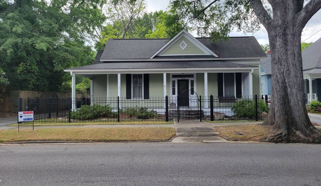 Lovely fenced and gated 3-bed/2 bath home on beautiful Elm lined Main Street.
