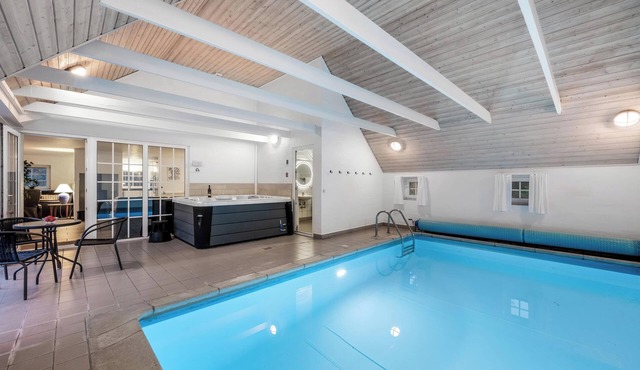 Lovely pool house with jumping cushion and activity room.