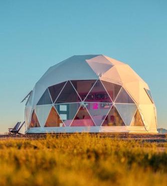Luminous Cozy Dome with a Barbie Collection Above Bed in Willcox, Arizona