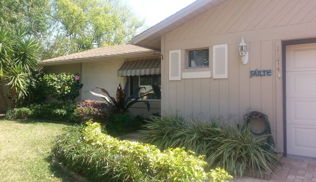 Lushly Landscaped Pool home Offers Tranquil Setting Yet Close to Beach