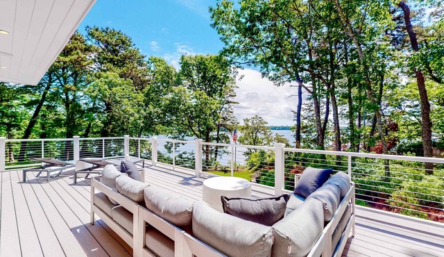 Luxe lakefront home on Follins Pond with private beach, amazing decks & yard