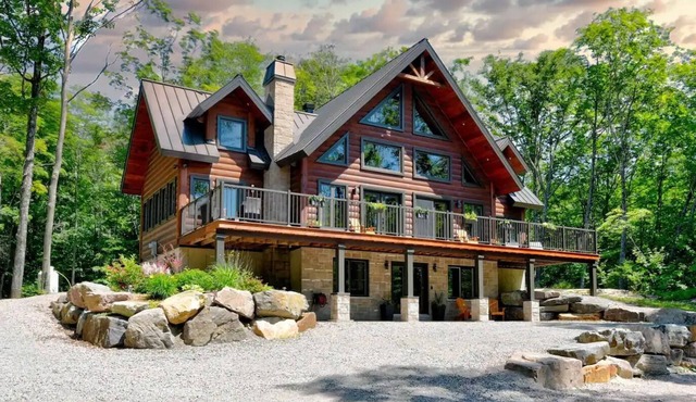 Luxurious chalet featuring a jacuzzi, pool, small lake, sauna and pool table.