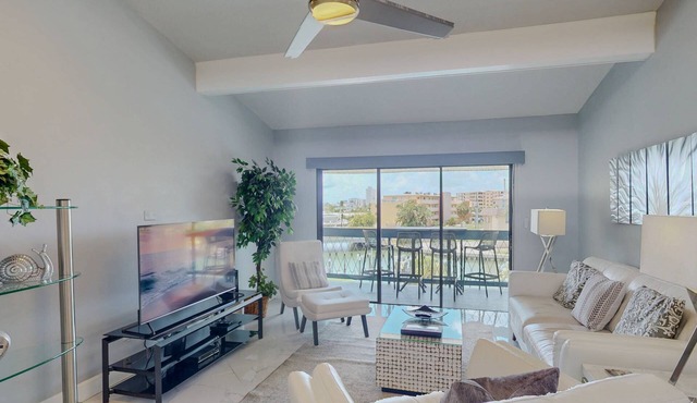Luxurious Coastal Condo with Waterway Views, Pool, Balcony, and Steps to Treasure Island Beach.