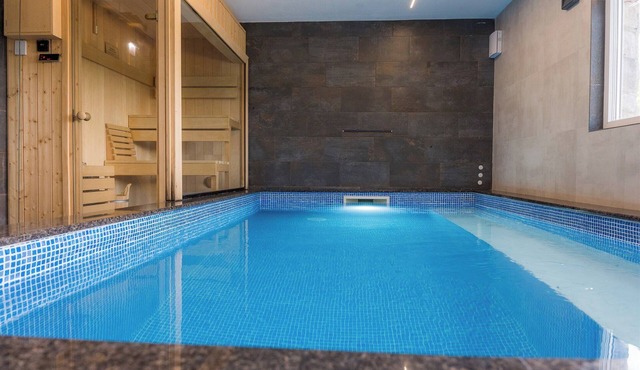 Luxurious riverside retreat with pool, sauna, jacuzzi, and panoramic nature views.