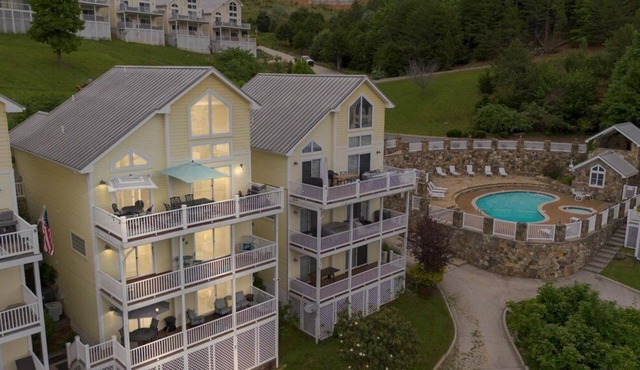 Luxury 5BR lakefront escape on Norris Lake, TN. Private dock, boat slip, pool, hot tub & outdoor tiki bar. 5 king beds sleep 10 in 3,200 sq ft of lakefront living near Deerfield Cove Marina.
