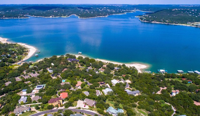 Luxury home with private boat dock, huge yard by the water, Sand Volleyball, Hot Tub, Lake views!